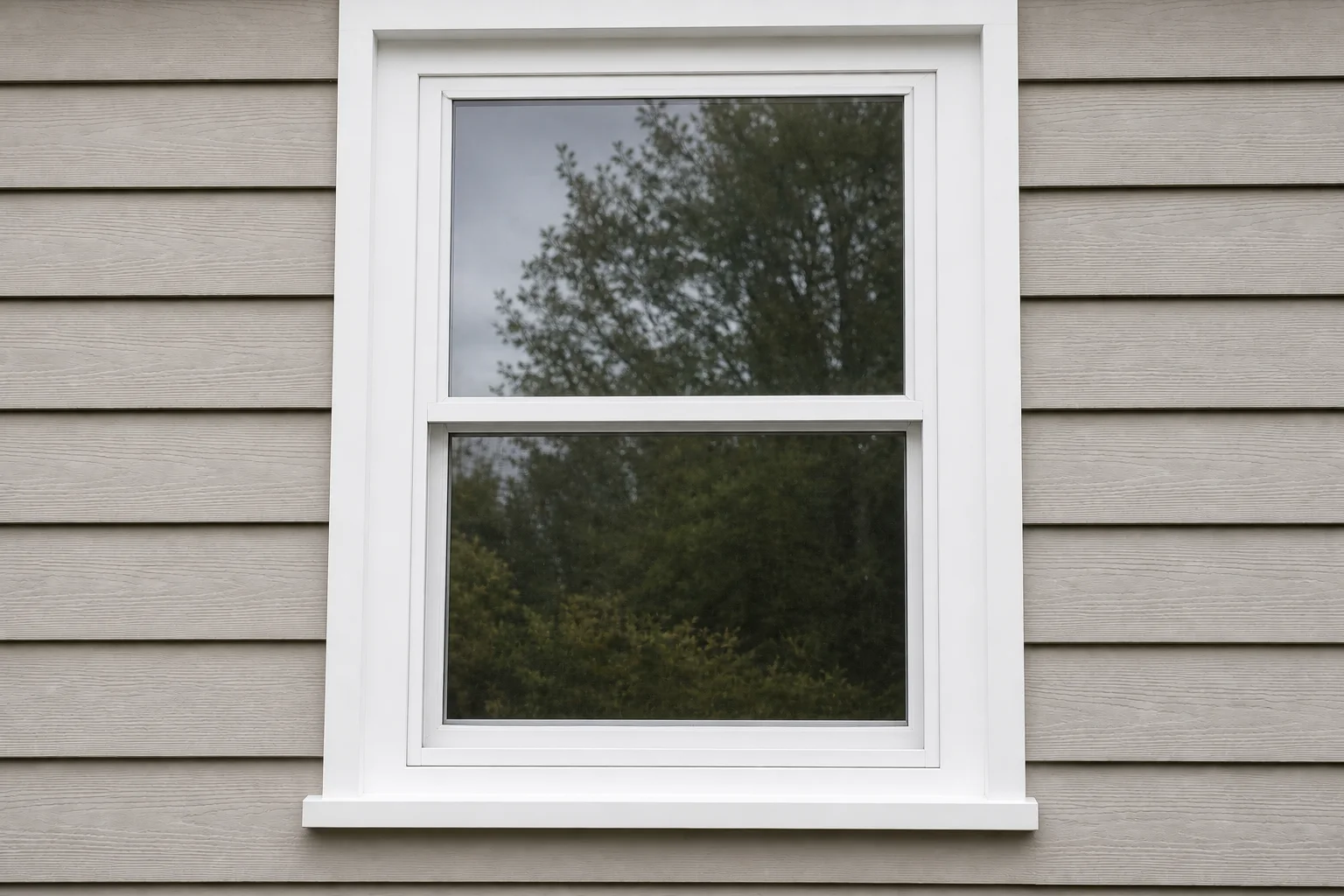 After: new white double-hung window with clear glass and freshly finished trim in the same opening.